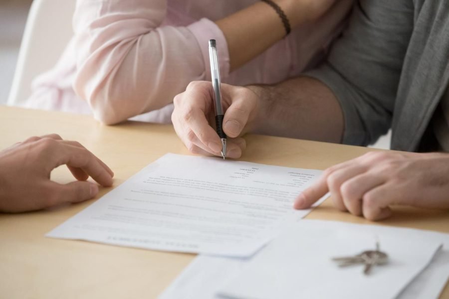 Couple signing rental sale purchase agreement buying renting hou
